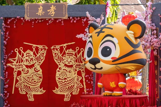 George Town, Penang, Malaysia - Jan 15 2022: Chinese tiger zodiac avatar decoration with red fabric. Chinese word mean filial piety
