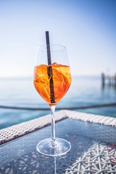 A luxurious bar setting on the Riviera, featuring exquisite glassware and a refreshing drink on a sleek bar table.