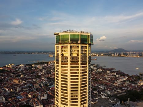 George Town, Penang, Malaysia - Jun 07 2022: Aerial view sun light evening at Komtar building and heritage George Town building at back
