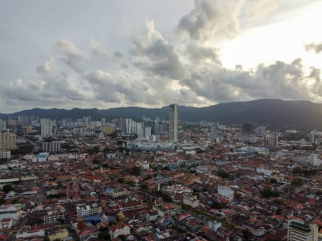 George Town, Penang, Malaysia - May 27 2022: Aerial view Komtar building and heritage old building in sunset cloud