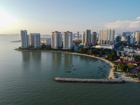 Tanjung Tokong, Penang, Malaysia - Mar 27 2022: Aerial view traditional fisherman jetty with background of high rise condominium building