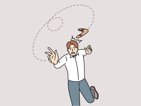 Frustrated man throw boomerang and element come back to him. Confused male employee suffer from effects of risky business. Boomerang effect. Vector illustration.