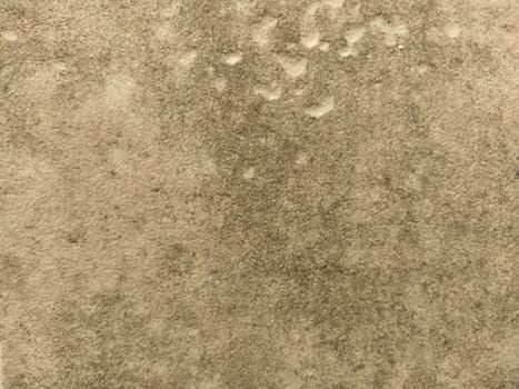 The textured surface of a concrete wall, marble or light stone with dark spots. Abstract background. Creative background light gray with red and brown pieces of moss, dirt and dust.