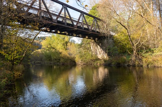 Old iron bridge over the river Eder with banks and trees in Hesse, Germany, Europe