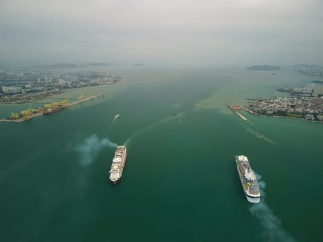 George Town, Penang, Malaysia - Aug 16 2022: Aerial view cruise ship move at different direction at Penang Port