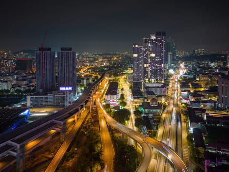 Bukit Bintang, Kuala Lumpur, Malaysia - Nov 28 2022: The city's roads and highways are brightly lit up, creating a mesmerizing pattern of light trails that showcase the city's bustling energy.