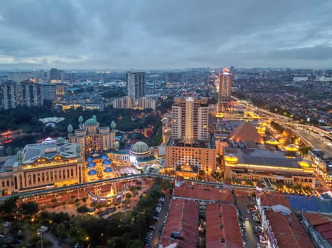 Sunway, Selangor, Malaysia - Nov 10 2022: Aerial view Sunway Resort in gold color and surround residential housing in blue hour