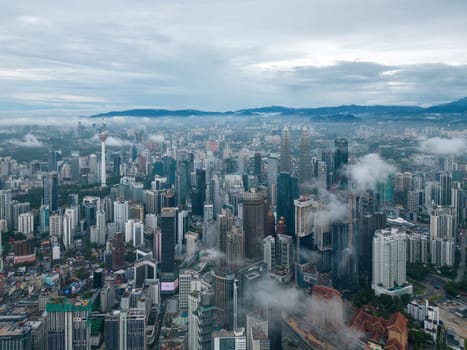 Bukit Bintang, Kuala Lumpur, Malaysia - Dec 03 2022: Aerial foggy cloud in KL city morning. Aerial view
