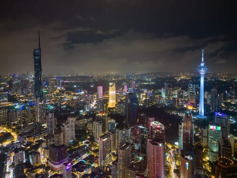 Bukit Bintang, Kuala Lumpur, Malaysia - Dec 03 2022: A stunning aerial shot of Kuala Lumpur's glittering skyline at night, showcasing the illuminated KL Towers, Merdeka 118 and other towering skyscrapers.