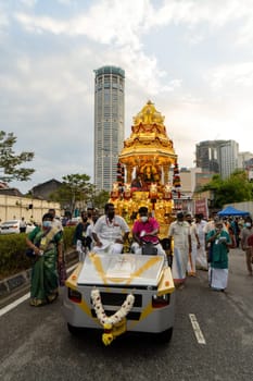 George Town, Penang, Malaysia - Jan 17 2022: Golden chariot pulled by car during procession Thaipusam