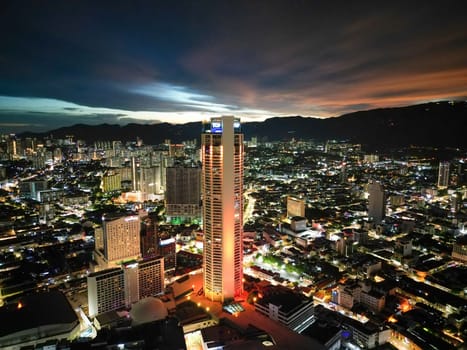 George Town, Penang, Malaysia - Sep 26 2022: Aerial view Komtar building and old heritage house light up during dusk hour