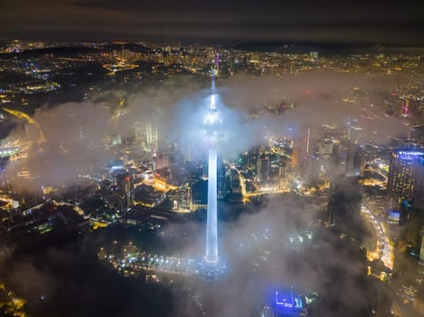 Bukit Bintang, Kuala Lumpur, Malaysia - Nov 12 2022: The KL Tower's illumination in night, creating a dynamic display of lights that adds to the excitement of the city's nightlife.