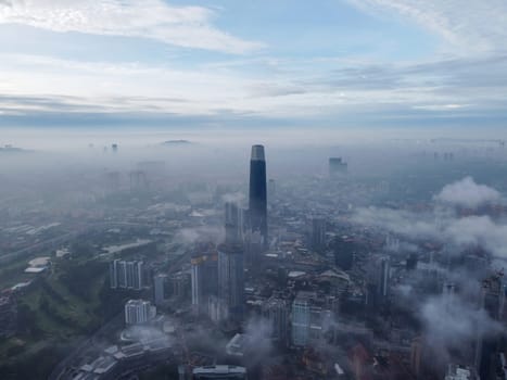 Bukit Bintang, Kuala Lumpur, Malaysia - Nov 13 2022: The Exchange 106 building looks majestic from an aerial view during the morning low cloud hours.
