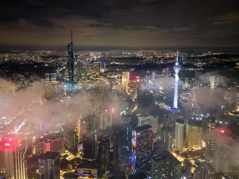 Bukit Bintang, Kuala Lumpur, Malaysia - Nov 12 2022: The view of the Merdeka 118 and KL tower's surrounding landscape during low cloud night provides a glimpse of the city's diversity