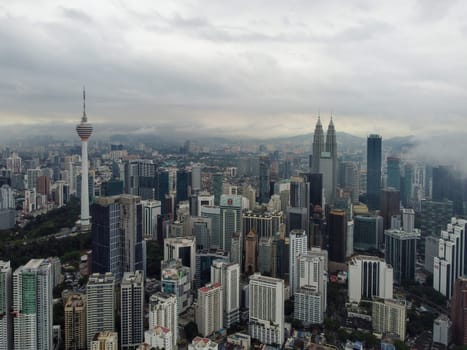 Bukit Bintang, Kuala Lumpur, Malaysia - Nov 12 2022: Aerial view KL tower and KLCC In misty day