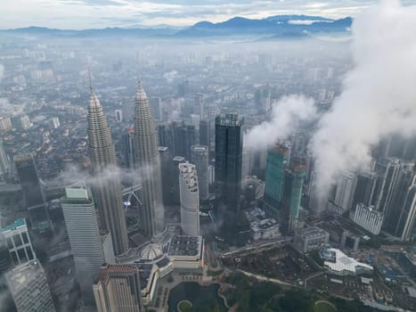 Bukit Bintang, Kuala Lumpur, Malaysia - Nov 13 2022: The KLCC's unique design and futuristic architecture stand out against the cloudy backdrop, adding to its grandeur.