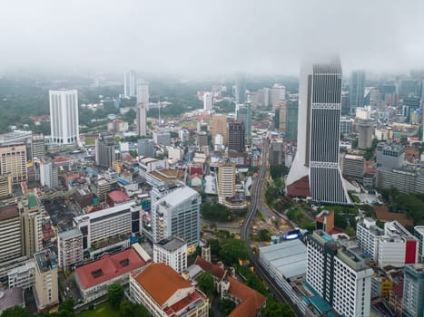 Bukit Bintang, Kuala Lumpur, Malaysia - Dec 03 2022: Aerial view Maybank tower during low cloud foggy morning