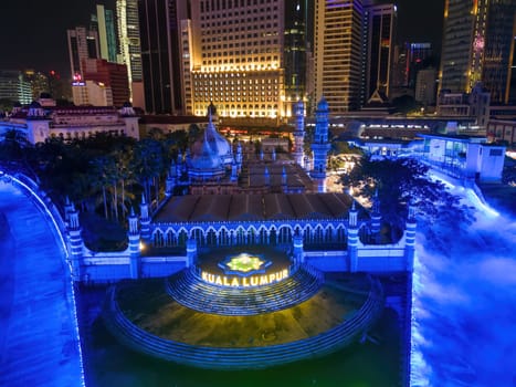 Bukit Bintang, Kuala Lumpur, Malaysia - Dec 03 2022: Aerial view Masjid Jamek with blue led decorated river