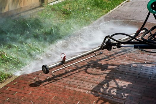 A special machine washes city paths and roads with water. High quality photo
