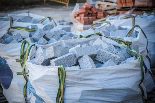 Raffia large sack full of granite cobblestones. Construction material concept