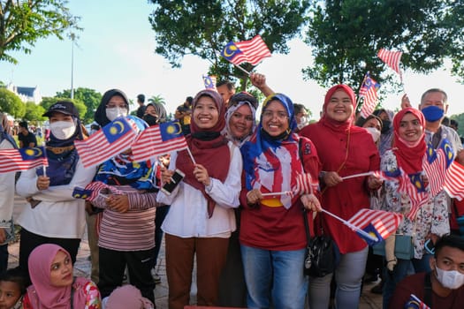 George Town, Penang, Malaysia - Aug 31 2022: Malaysian raise the Jalur Gemilang Malaysia flag during celebrate Merdeka