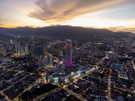 George Town, Penang, Malaysia - Aug 17 2022: Aerial view George Town is light up during dramatic sunset hour