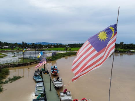 Seberang Perai, Penang, Malaysia - Oct 16 2022: Malaysia flag with background of fishing jetty