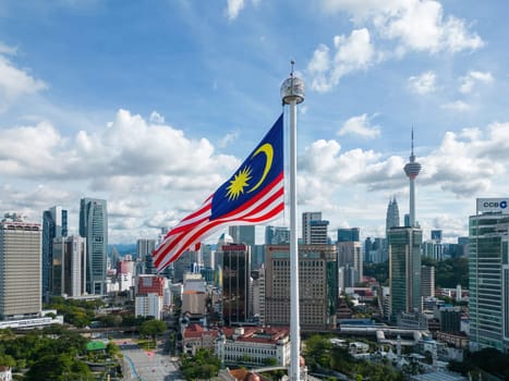 Bukit Bintang, Kuala Lumpur, Malaysia - Dec 05 2022: Malaysia flag at Dataran merdeka with background of Kuala Lumpur city