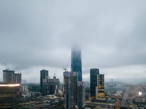 Bukit Bintang, Kuala Lumpur, Malaysia - Dec 03 2022: The low clouds seem to envelop the building, giving it an ethereal quality that's hard to miss.