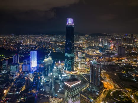 Bukit Bintang, Kuala Lumpur, Malaysia - Nov 30 2022: Skyscrapers TRX Exchange 106 light up the night sky. Aerial view