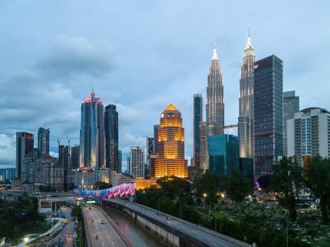 Bukit Bintang, Kuala Lumpur, Malaysia - Dec 03 2022: Pintasan Saloma with led of Malaysia flag design with background of KLCC in blue hour