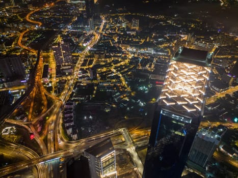 Bukit Bintang, Kuala Lumpur, Malaysia - Nov 12 2022: The Pavilion Kuala Lumpur, highway and skyscraper building in aerial view at night