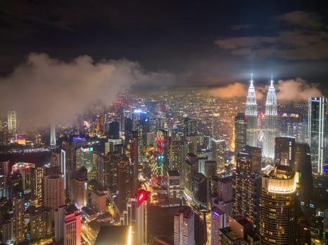 Bukit Bintang, Kuala Lumpur, Malaysia - Nov 12 2022: The KLCC twin tower's design and architecture in low cloud night