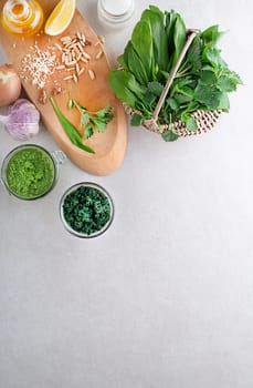Spring healthy food. Nettle and ramson pesto for healthy meal on grey background