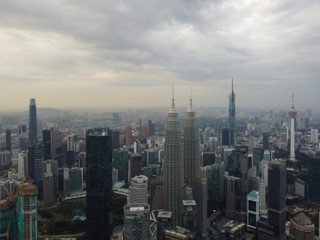 Bukit Bintang, Kuala Lumpur, Malaysia - Dec 25 2022: Aerial shot of Kuala Lumpur's skyline, showcasing the city's iconic Petronas Twin Towers and other towering skyscrapers.