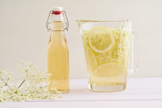 Elderflowers,sugar and lemons in a bottle for the production of elderflower syrup