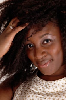 A lovely closeup portrait picture of a African American woman, smiling in a .beige dress, isolated for white background..