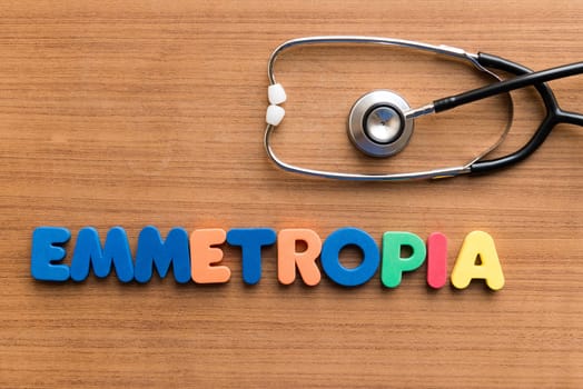 emmetropia colorful medical word and stethoscope on the wooden background