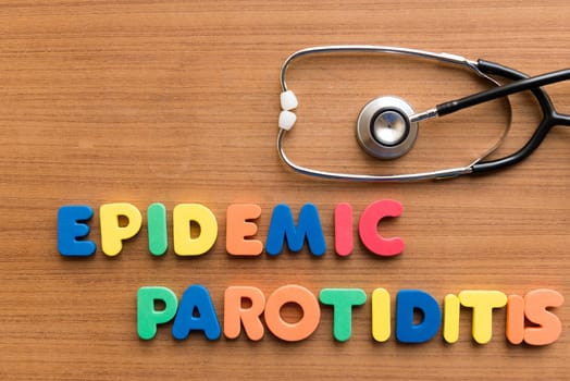 epidemic parotiditis colorful medical word and stethoscope on the wooden background