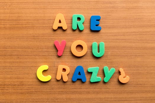 are you crazy colorful words on the wooden background