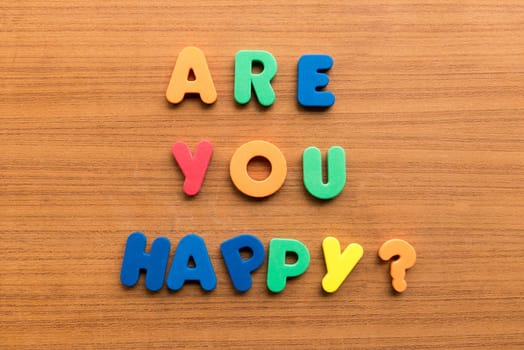are you happy colorful words on the wooden background