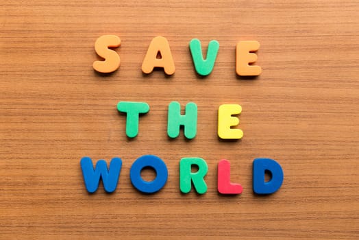 save the world colorful words on the wooden background