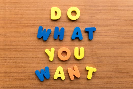 do what you want colorful words on the wooden background