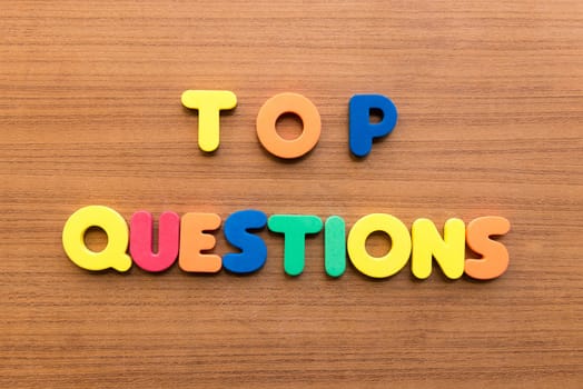 top questions colorful words on the wooden background