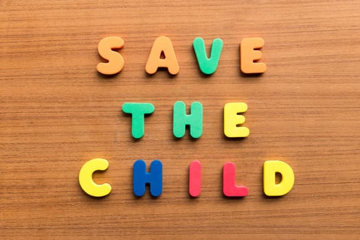 save the child colorful words on the wooden background
