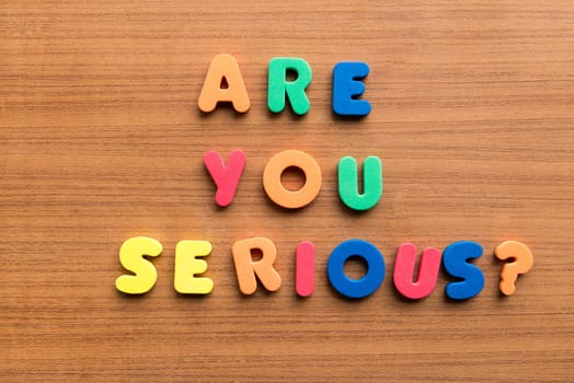 are you serious colorful words on the wooden background