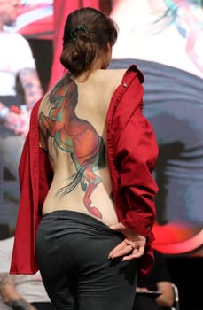 Krakow, Poland - June 11, 2022: Unidentified participant during the contest for the best tattoo at the 15th Tattoofest Convention in Cracow. One of the most prestigious tattoo festivals.