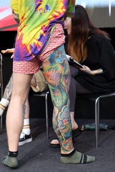 Krakow, Poland - June 12, 2022: Unidentified participant during the contest for the best tattoo at the 15th Tattoofest Convention in Cracow. One of the most prestigious tattoo festivals.