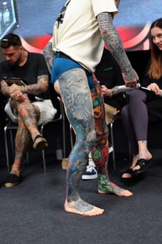 Krakow, Poland - June 12, 2022: Unidentified participant during the contest for the best tattoo at the 15th Tattoofest Convention in Cracow. One of the most prestigious tattoo festivals.
