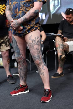 Krakow, Poland - June 12, 2022: Unidentified participant during the contest for the best tattoo at the 15th Tattoofest Convention in Cracow. One of the most prestigious tattoo festivals.